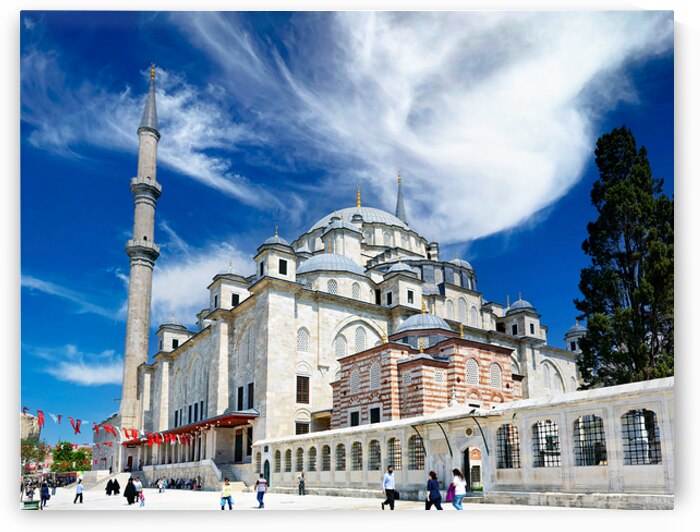 Visitors explore Fatih Mosque in Istanbul on a sunny day by Marco Brivio