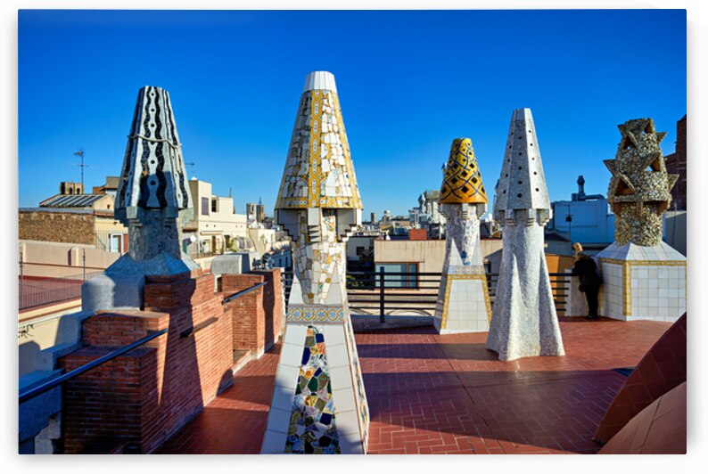 Palau Guell roof with Gaudi sculptures under clear sky by Marco Brivio