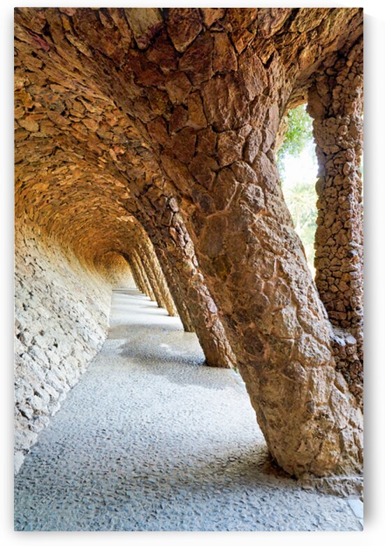 Walking through the colonnaded pathway in Park Guell Barcelona by Marco Brivio