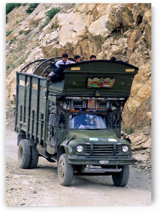 Freight truck carries passengers on rocky road in Pakistan by Marco Brivio