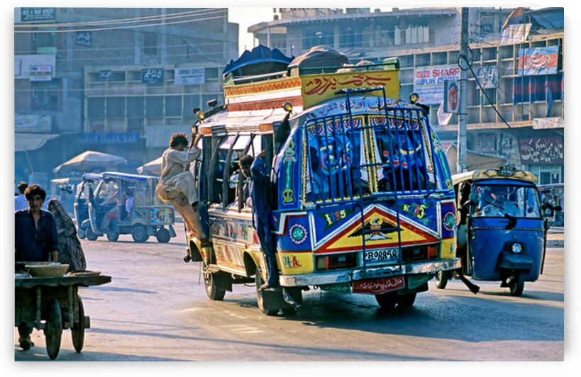 Busy streets of Peshawar with colorful buses and rickshaws by Marco Brivio