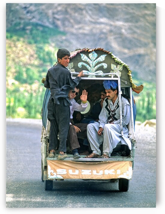 People traveling in a Suzuki on the road to Chitral in Pakistan by Marco Brivio