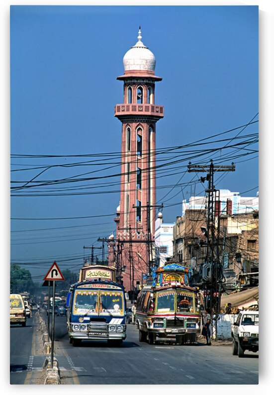 Busy street scene with tall tower in Peshawar Pakistan by Marco Brivio