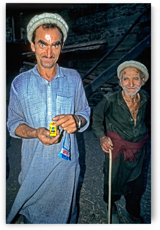 Men show toy in Kalash Village during evening hours by Marco Brivio