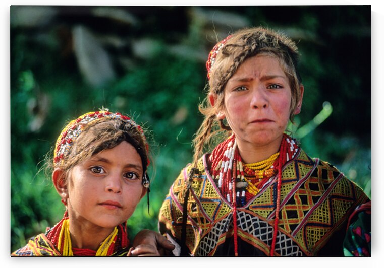 Children of Pakistan wear traditional clothing in the sunlight by Marco Brivio