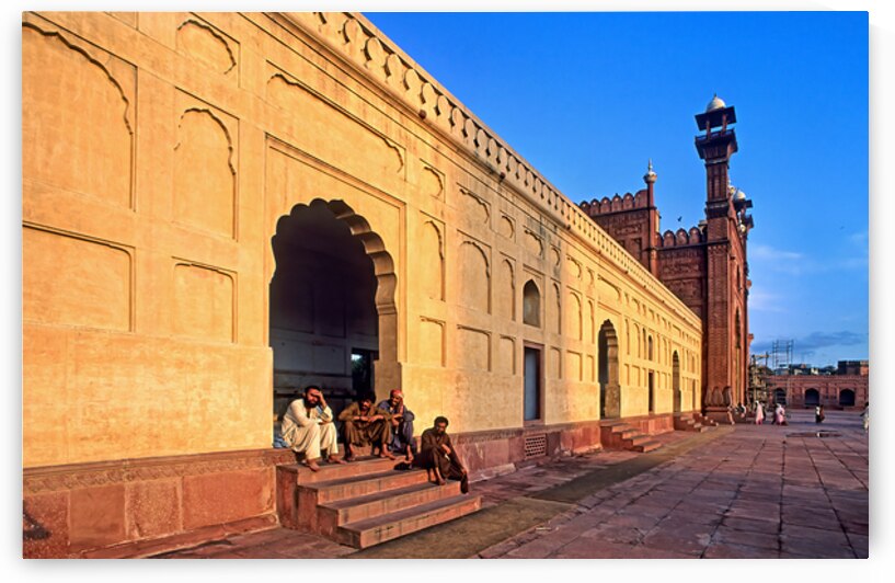 Visitors rest by Badshahi Mosque during sunset in Lahore by Marco Brivio