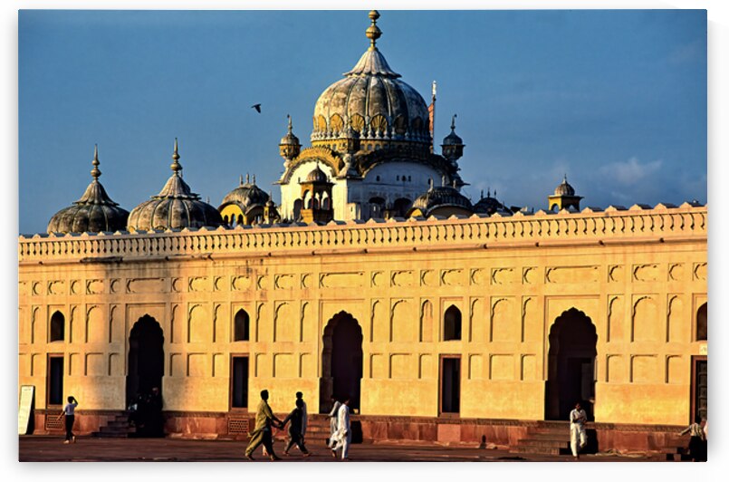 Visitors explore Badshahi Mosque in Lahore at sunset by Marco Brivio