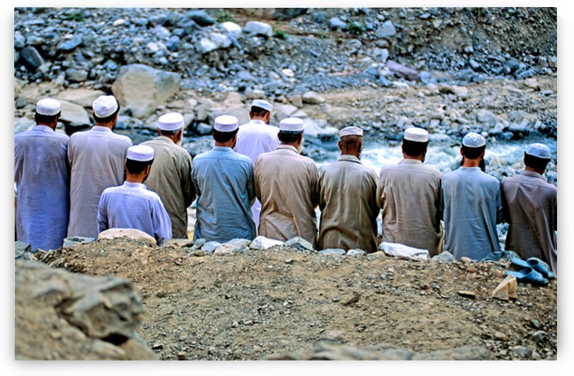Muslim men pray outdoors in Pakistan facing Mecca by Marco Brivio
