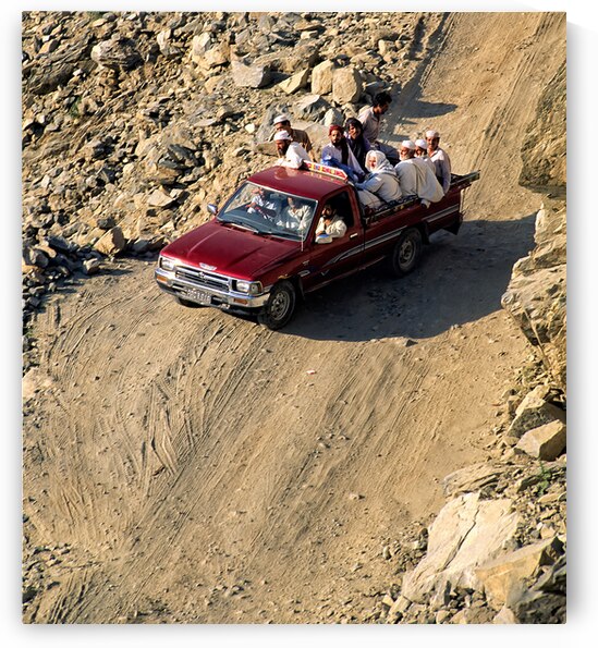 Travelers on gravel road near Shandur Pass in Pakistan by Marco Brivio
