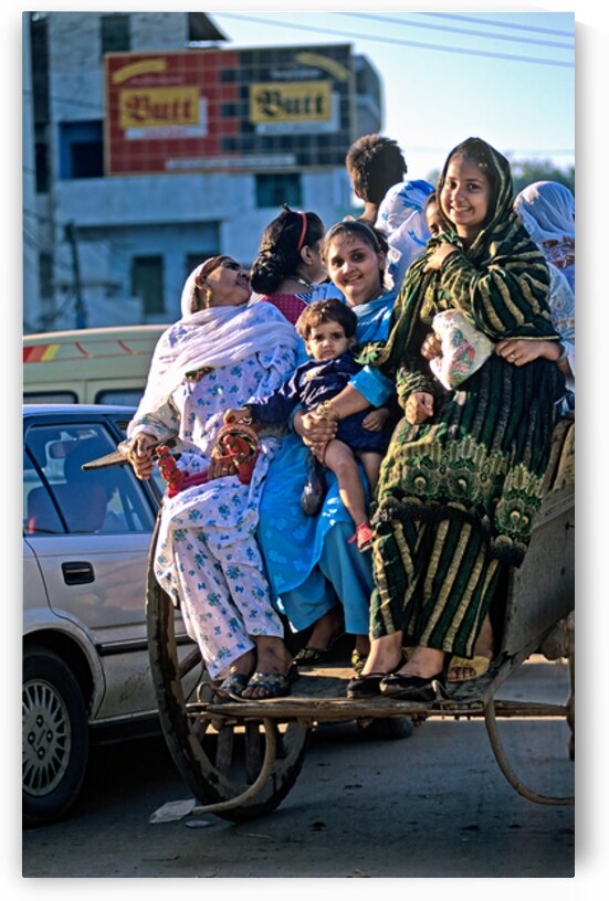 Family travels on rickshaw in busy Lahore streets by Marco Brivio