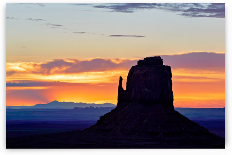 Sunset view over Monument Valley in Utah with dark silhouettes by Marco Brivio