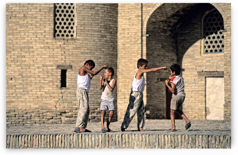 Children playing together in Bukhara Uzbekistan by Marco Brivio