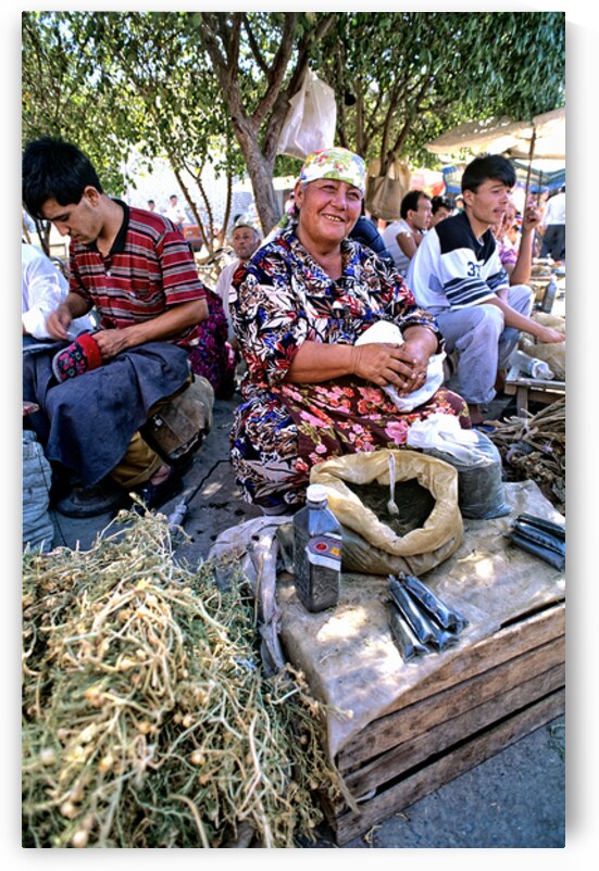 Local woman prepares herbs at market in Khiva Uzbekistan by Marco Brivio