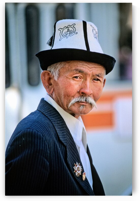 Elderly man in traditional hat walks in Bukhara Uzbekistan by Marco Brivio