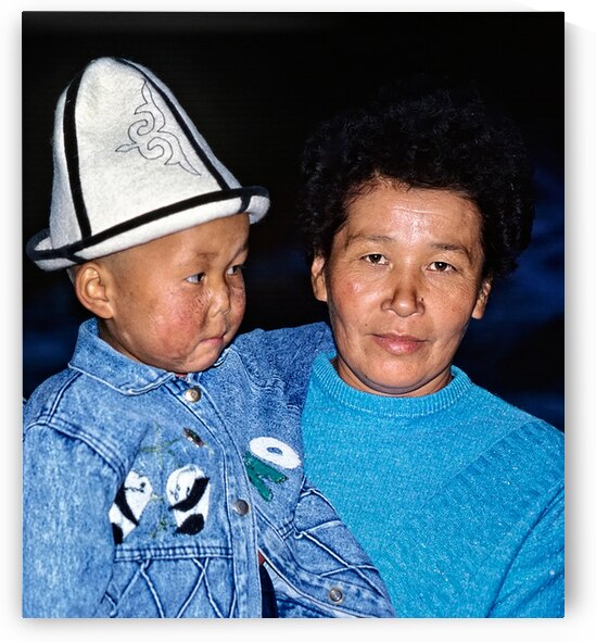 Uzbekistan mother and child in traditional attire during daytime by Marco Brivio