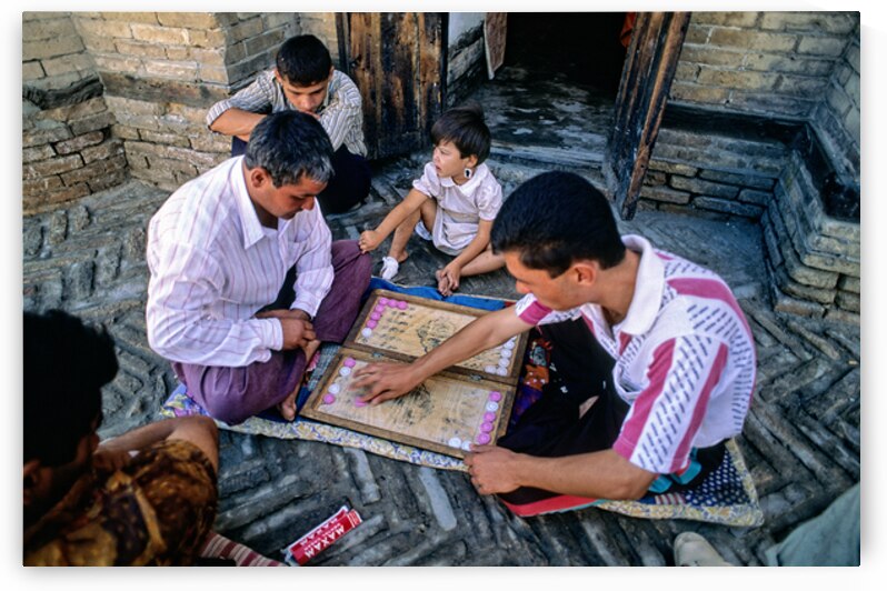 Men playing a board game in daylight in Khiva by Marco Brivio