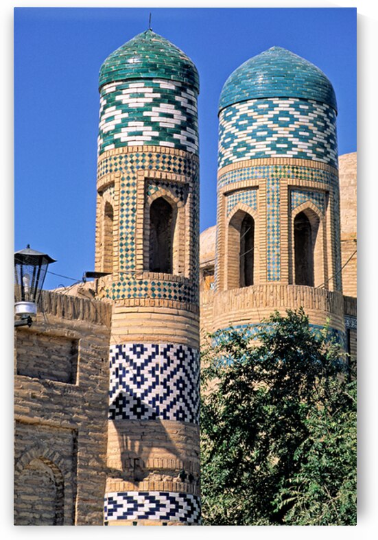 Exploring historic towers in Khiva Uzbekistan under clear sky by Marco Brivio