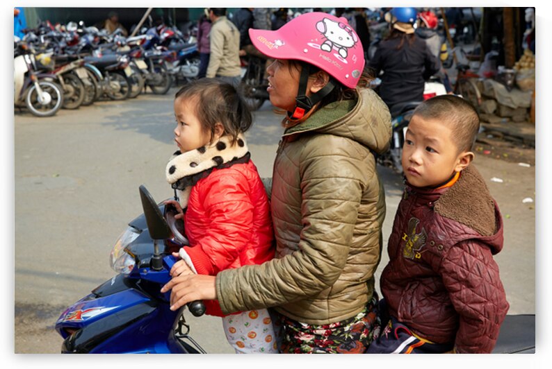 Children riding a motorbike in Hanoi streets by Marco Brivio