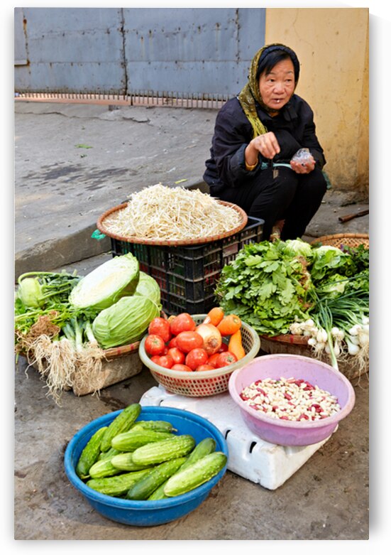Woman sells fresh vegetables in Hanoi market by Marco Brivio