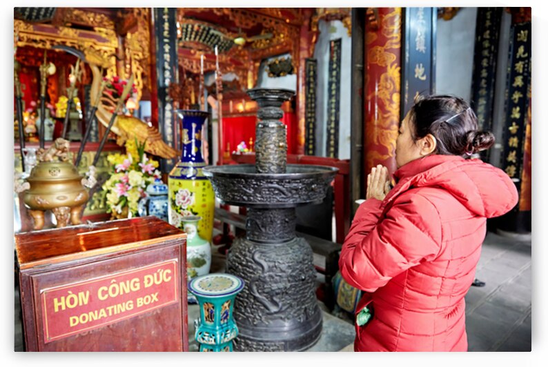 Praying at a temple in Ho Chi Minh City Vietnam by Marco Brivio