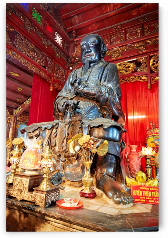 Statue of a monk in Ho Chi Minh City with traditional offerings by Marco Brivio