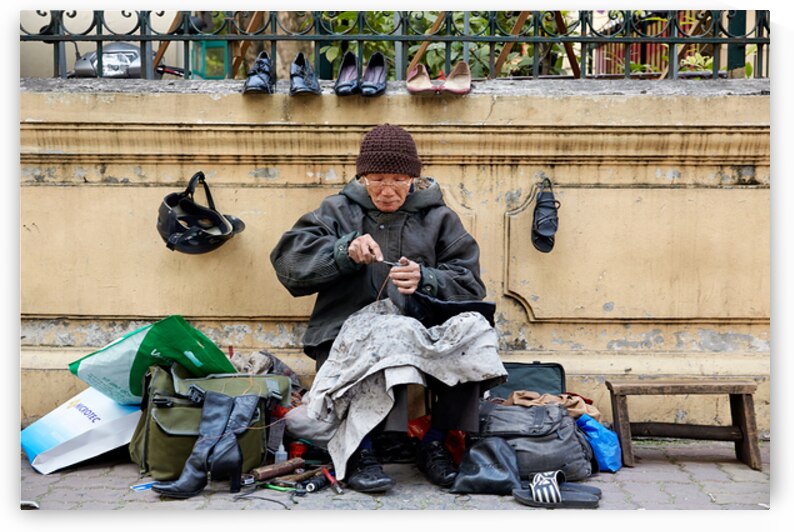Hanoi cobbler repairs shoes on busy street in Vietnam by Marco Brivio