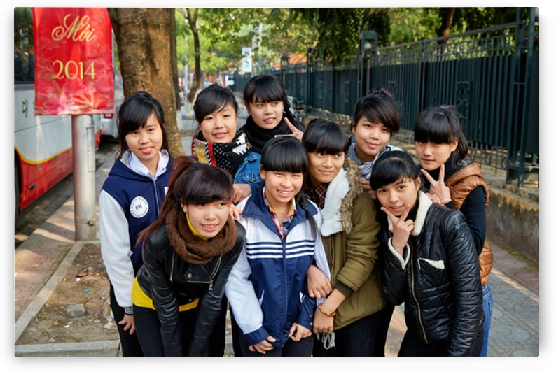 A group of young girls smiles and poses together in Hanoi by Marco Brivio