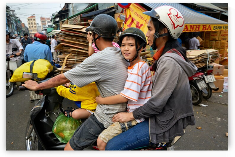 Traffic in Ho Chi Minh City with a family on a motorbike by Marco Brivio