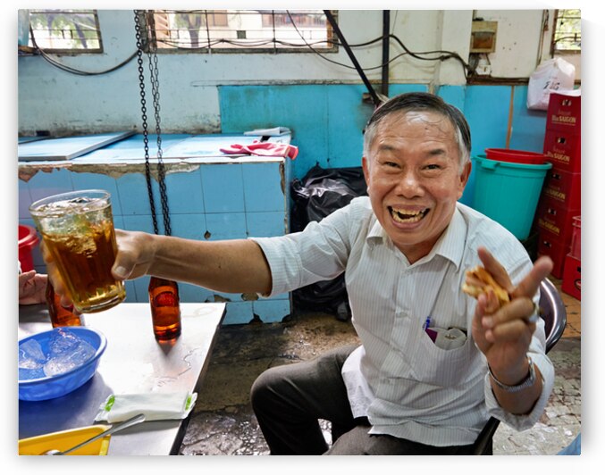 Man enjoying drink and food at cafe in Ho Chi Minh City by Marco Brivio