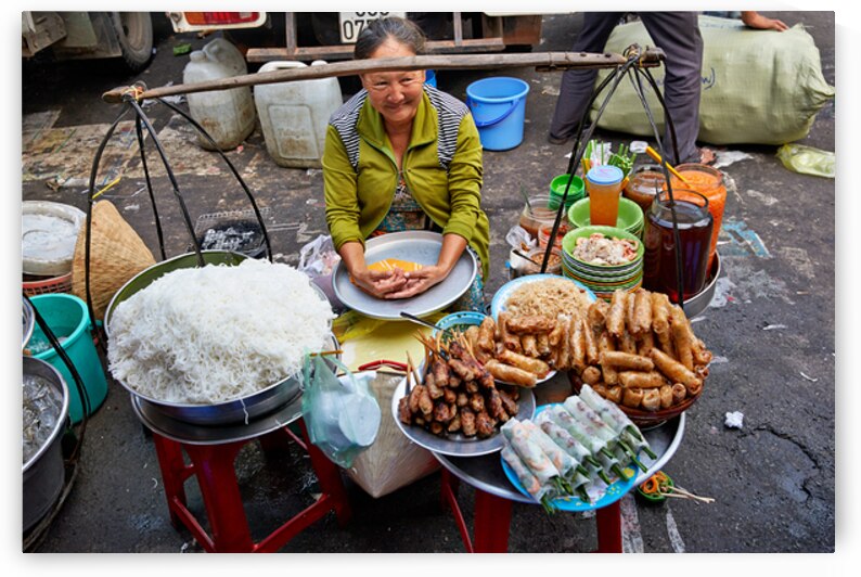 Woman selling food at street market in Ho Chi Minh City by Marco Brivio