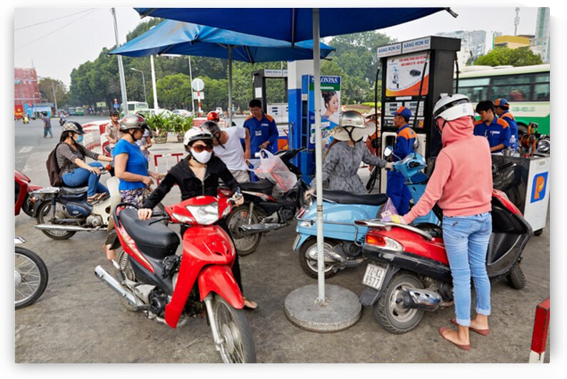 People refueling motorbikes at a gas station in Ho Chi Minh City by Marco Brivio