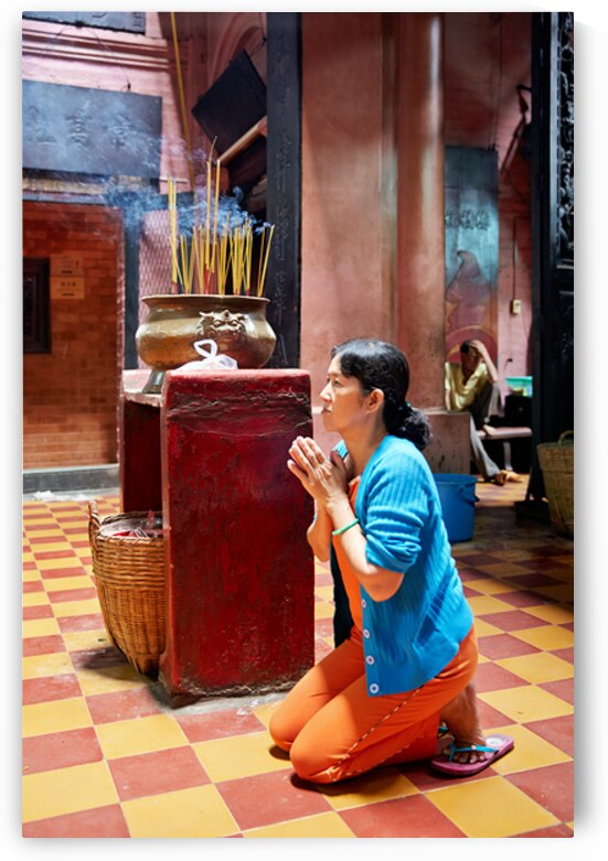 Woman prays at a temple in Ho Chi Minh City Vietnam by Marco Brivio