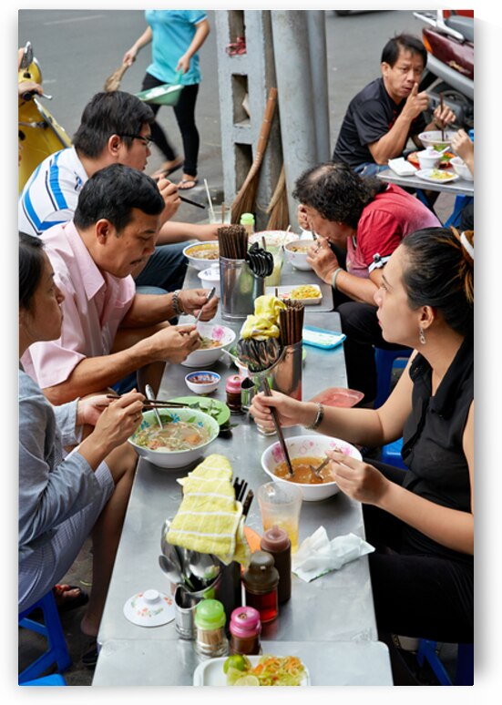 People eating at street food stalls in Ho Chi Minh City by Marco Brivio