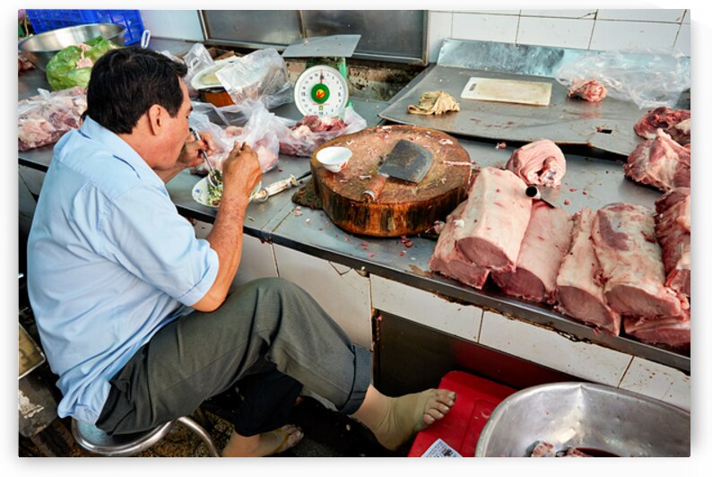 Meat vendor prepares pork at market in Ho Chi Minh City by Marco Brivio