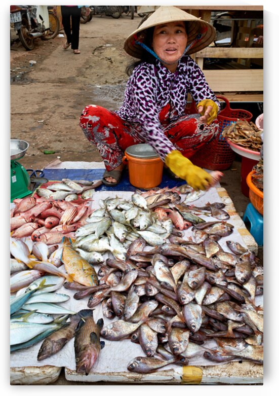Fish seller in Phu Quoc market shows fresh catch for sale by Marco Brivio