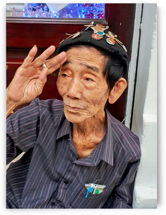 Old man salutes in Ho Chi Minh City streets by Marco Brivio