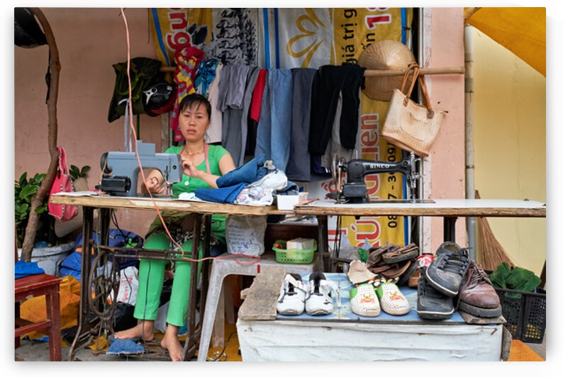Sewing clothes at a market stall in Phu Quoc Vietnam by Marco Brivio