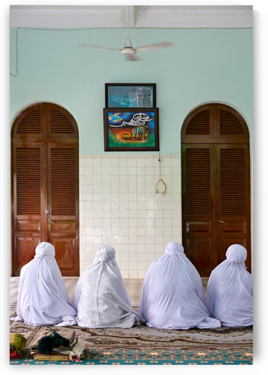 Muslim women pray in a room in Ho Chi Minh City by Marco Brivio