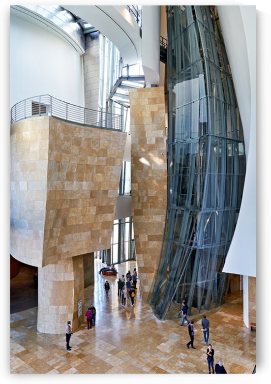 People walk through the Guggenheim Museum in Bilbao Spain by Marco Brivio
