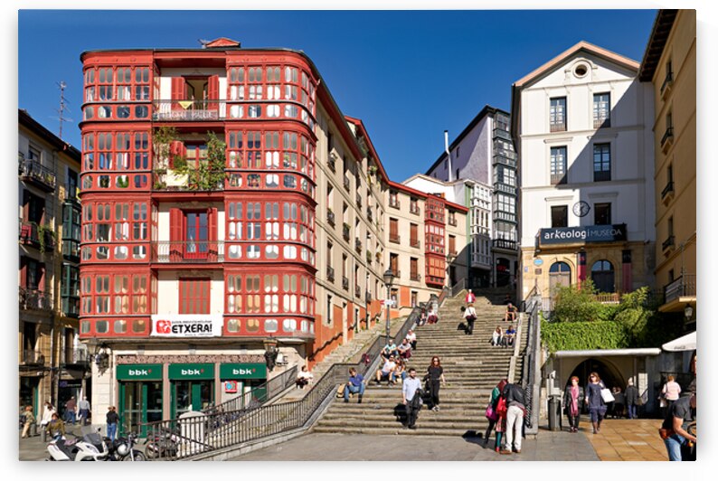 Stairs and buildings in downtown Bilbao Spain during the day by Marco Brivio