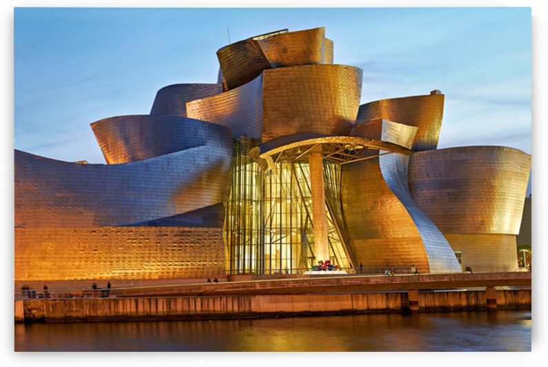 Guggenheim Museum at dusk in Bilbao Spain with lights on by Marco Brivio