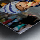 Child enjoys snack while riding tricycle in Hanoi streets Metal print