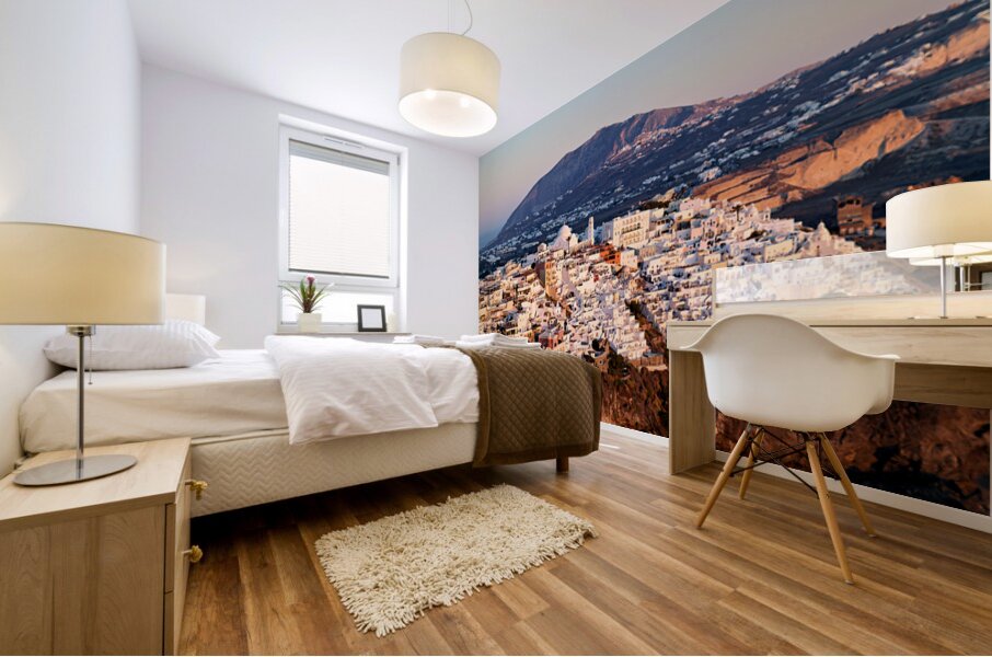 Santorini cliffside town at sunset with mountain backdrop. Mural print