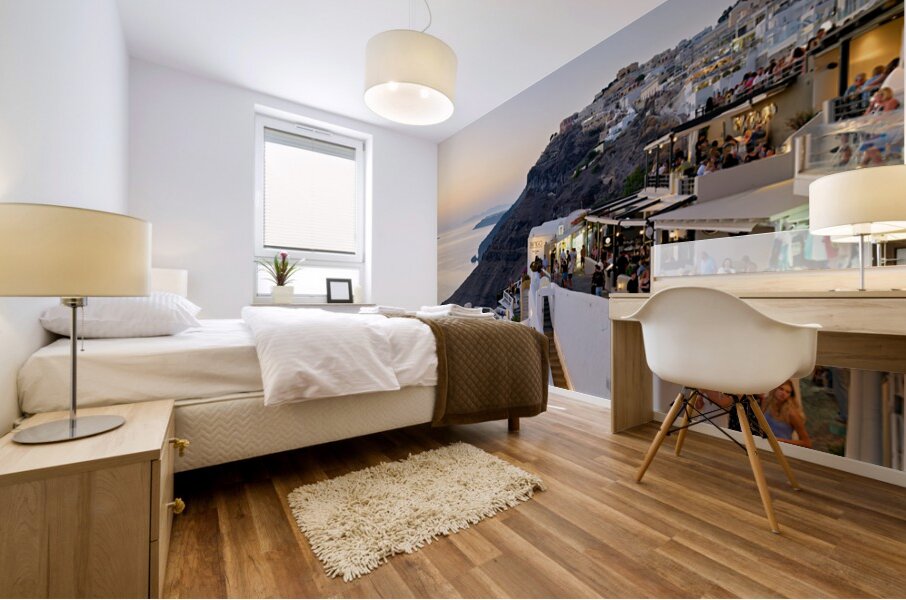 Santorini cliffside town with restaurants and people enjoying th Mural print