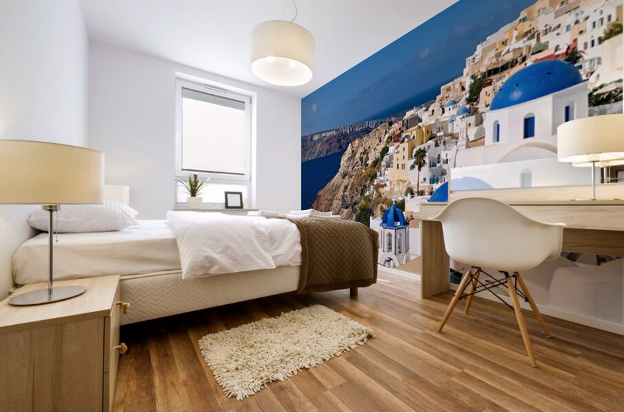 Santorinis iconic white buildings and blue domes overlooking th Mural print