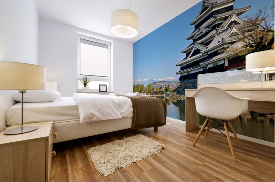 Matsumoto Castle stands beside water with mountains in the dista Mural print