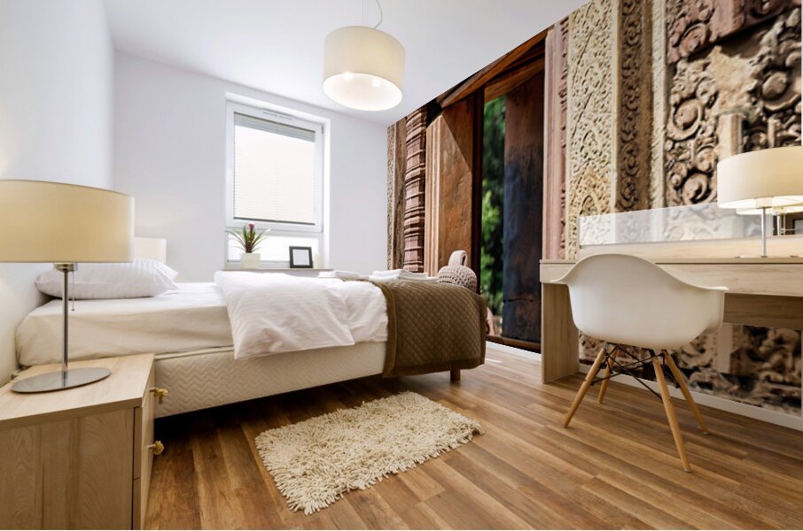 Ancient Cambodian temple with intricate carvings and stone statu Mural print