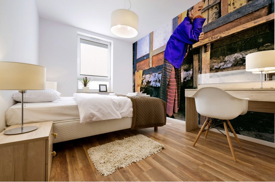 Smiling elderly woman in traditional dress leaning on wooden tab Mural print