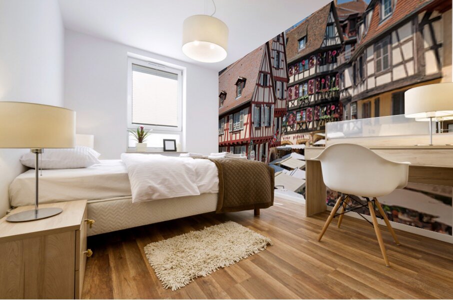 Visitors walk through Colmar on sunny day near timber framed hou Mural print