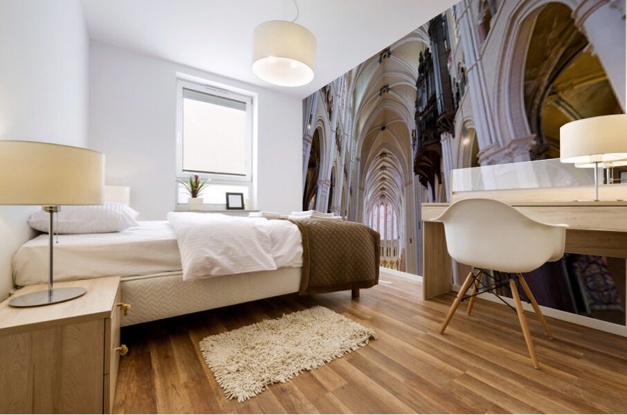 Chartres Cathedral inside with tall arches and wooden chairs Mural print